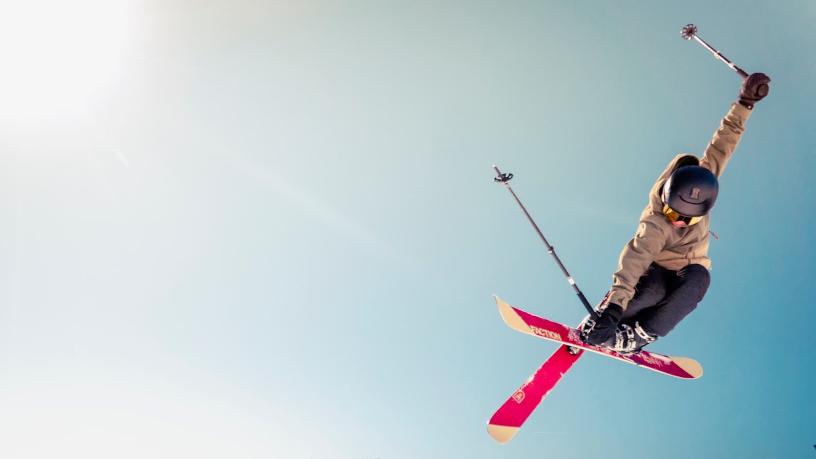 Skier in the air against a blue sky